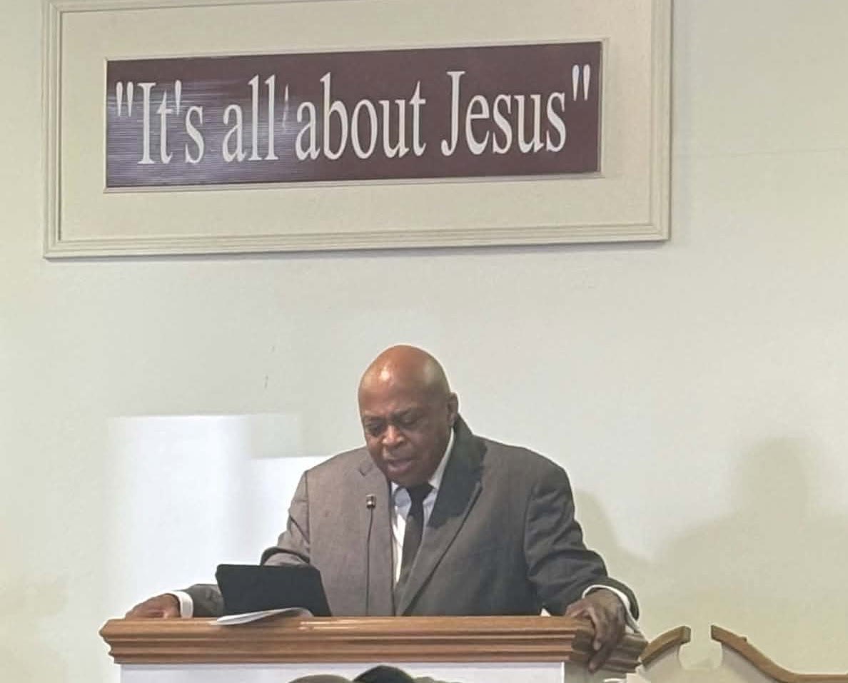 Pastor Charles James speaking at the pulpit